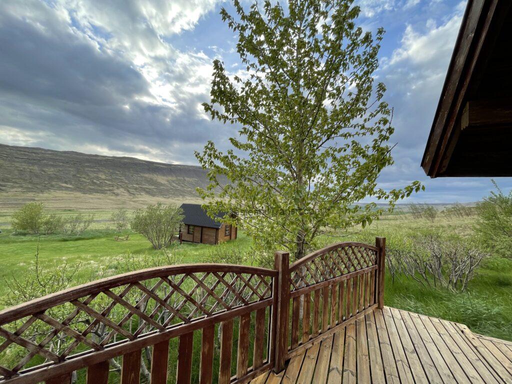 Cozy wooden cottage and patio deck amidst green fields in Iceland